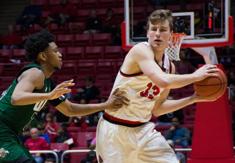 Senior forward Ryan Weber looks for a teammate to pass the ball to at the game against Ohio on Feb. 10 in Worthen Arena. Weber scored 11 points during the game against the Bobcats. Kaiti Sullivan // DN