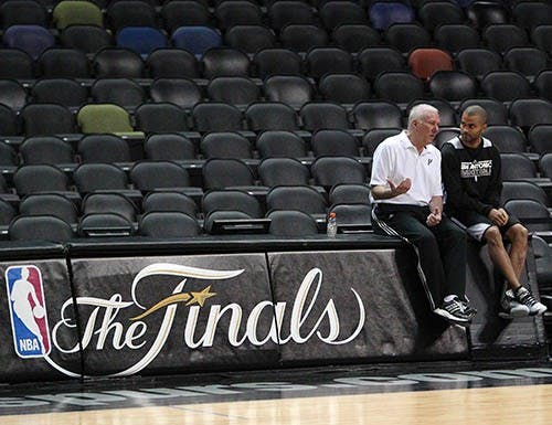 San Antonio head coach Gregg Popovich talks with guard Tony Parker during the team’s practice session on Wednesday before tonight’s Game 4 of the NBA Finals against the Miami Heat. The Spurs hold a 2-1 advantage. MCT PHOTO