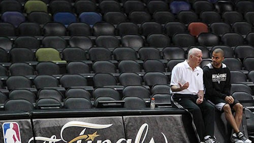 San Antonio head coach Gregg Popovich talks with guard Tony Parker during the team’s practice session on Wednesday before tonight’s Game 4 of the NBA Finals against the Miami Heat. The Spurs hold a 2-1 advantage. MCT PHOTO