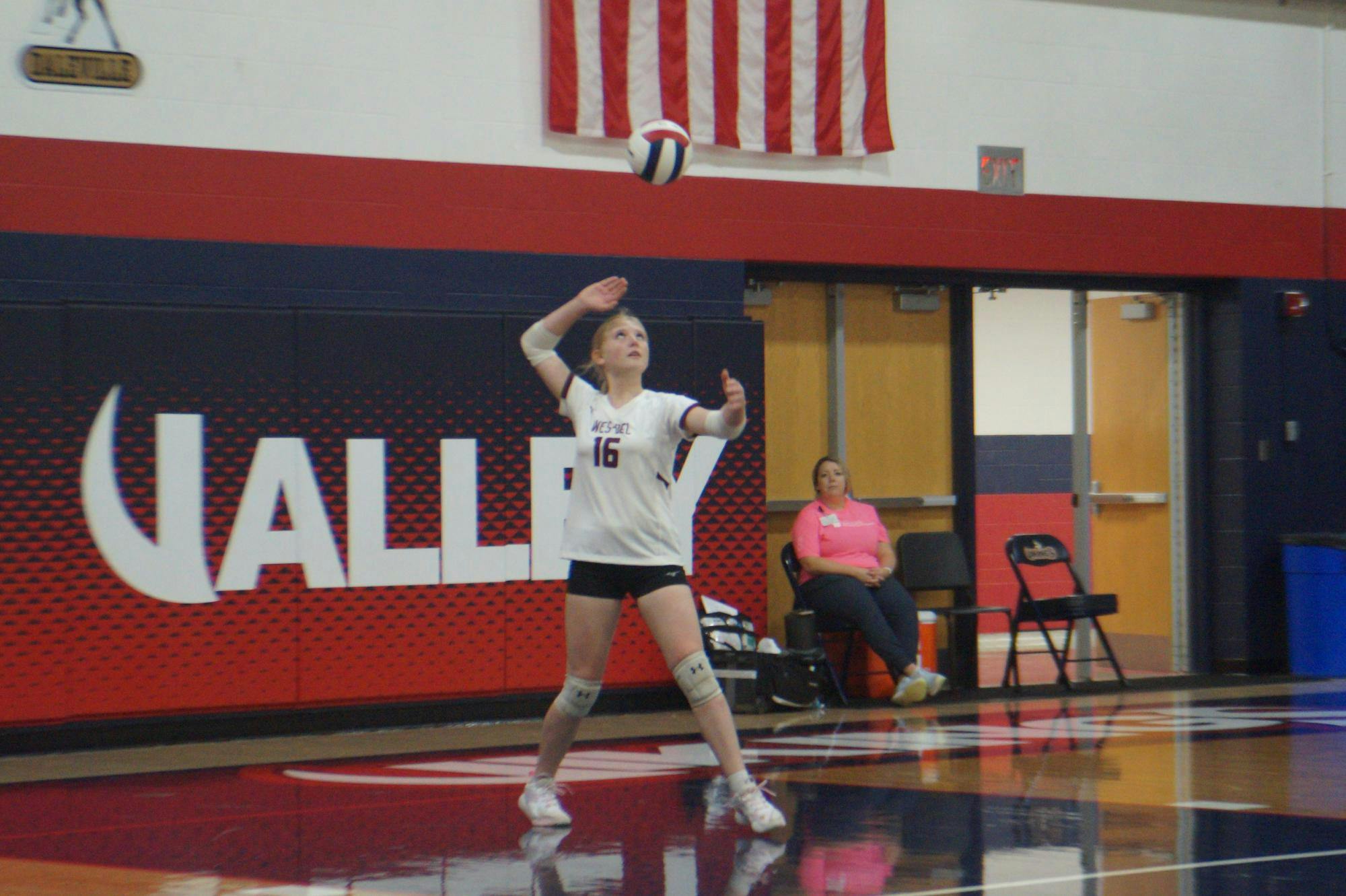 Freshman Lillian Byrd readies a serve to send flying into the opposing team. The Warriors will fight again Sept. 30, taking on the Eastbrook Panthers. SECOND PHOTO BY NICK ROARK
