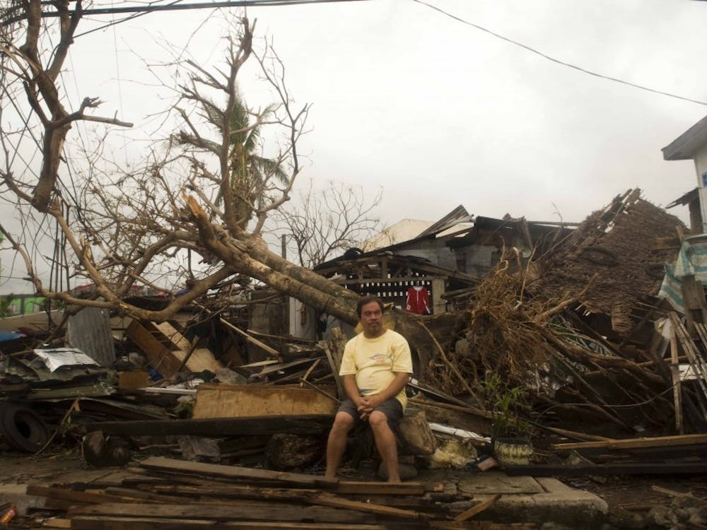 A resident sits on debris in typhoon-hit Leyte Province, Nov. 12, 2013. The United Nations said it had released $25 million in emergency funds to pay for emergency shelter materials and household items, and for assistance with the provision of emergency health services, safe water supplies and sanitation facilities. It's launching an appeal for more aid. MCT PHOTO