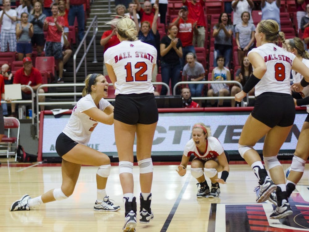 Members of the women's volleyball team celebrate after winning the match in the second game of the Active Ankle Tournament against Belmont on Aug. 28 at Worthen Arena. DN PHOTO BREANNA DAUGHERTY