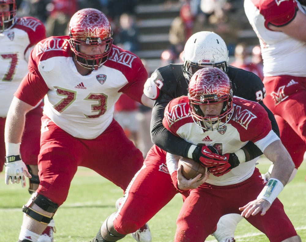 Senior defensive tackle Nathan Ollie attempts to bring down the Miami ball carrier during the game Nov. 29. Ball State won the game 55-14. DN PHOTO JONATHAN MIKSANEK