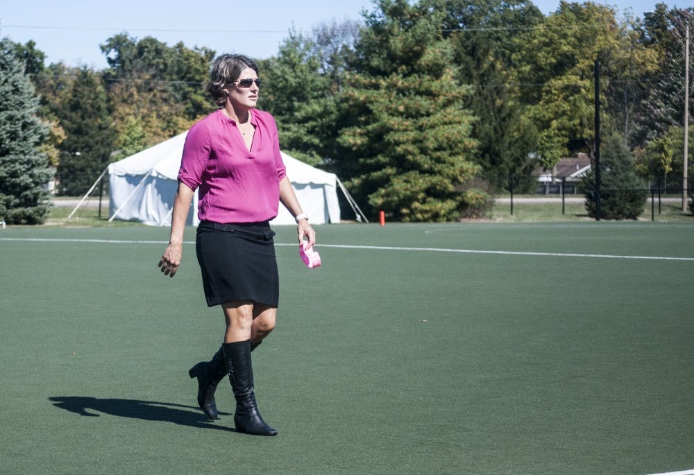 Ball State field hockey coach Sally Northcroft walks off the field during halftime of the "Think Pink" game against Bellarmine University. Though Northcroft's Cardinals have struggled so far this season, they came alive to beat Bellarmine, 7-1. DN PHOTO COLIN GRYLLS
