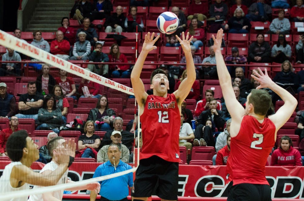 <p>Sophomore Jake Romano sets the ball to senior Anthony Lebryk during a match against Lewis University on Feb. 16 in John E. Worthen Arena. <strong>Madeline Grosh, DN</strong></p>