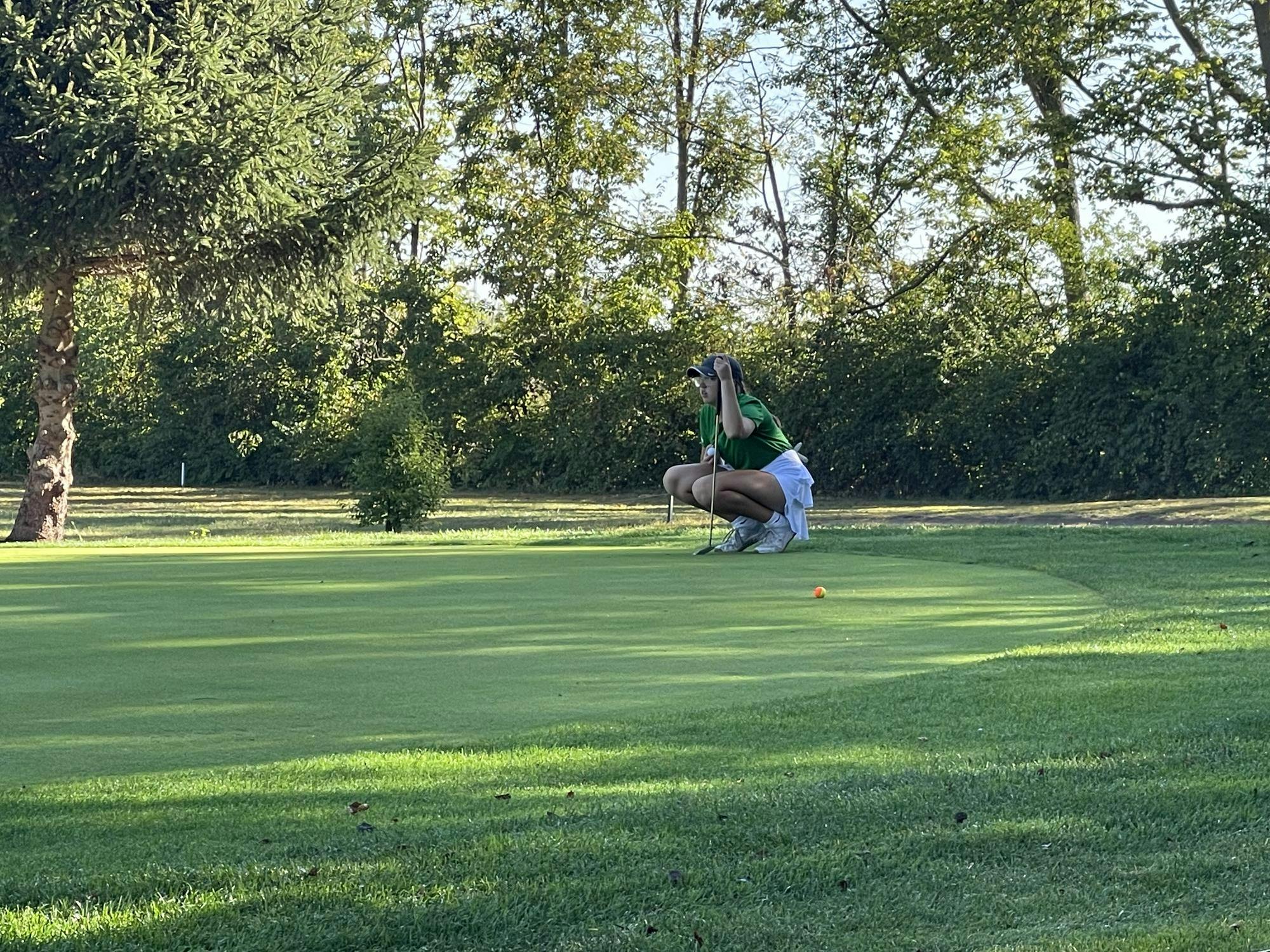 Grace Turner, junior, lines up her birdie putt on the fifth hole at Crestview Golf Club. Turner’s birdie helped place her tied ninth and the Tigers to a 3rd place finish at the sectional championship. Photo by: Landon Case.