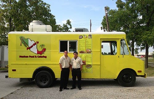 Manager Emanuel Escamilla (left) and assistant manager Ricardo Garcia pose by their food truck. The Puerta’s food truck has been out since the Delaware County Fair. DN PHOTO JEREMY ERVIN