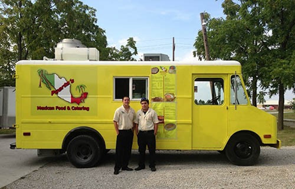 Manager Emanuel Escamilla (left) and assistant manager Ricardo Garcia pose by their food truck. The Puerta’s food truck has been out since the Delaware County Fair. DN PHOTO JEREMY ERVIN