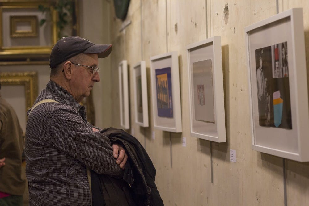 Garry Mashino looks at artwork at Gordy Fine Art & Framing Co. in Muncie on Nov. 7. That evening, Gordys featured the work of five former employees who all graduated from Ball State. DN PHOTO EMMA ROGERS