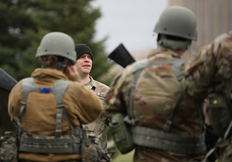 Military science instructor Mark White talks with Ball State ROTC cadets as they wait for a helicopter to arrive March 24 near the Glick Center For Glass. Cadets from Indiana Wesleyan University, Ball State and Purdue Fort Wayne will participate in training at Camp Atterbury over the weekend. Rylan Capper, DN 