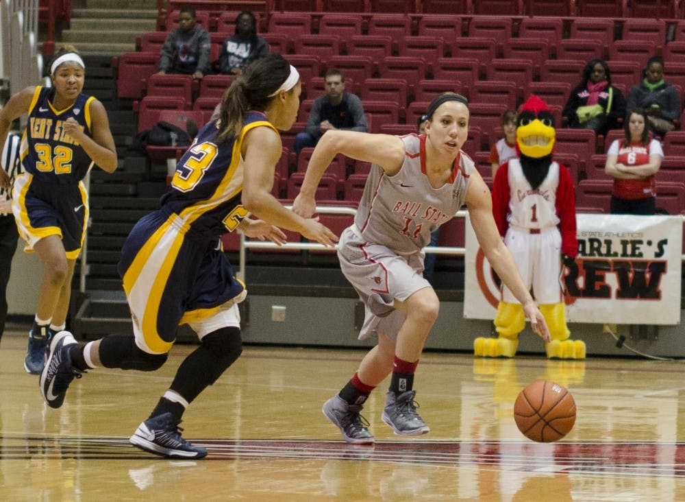 Senior guard Brandy Woody dribbles the ball past Kent State