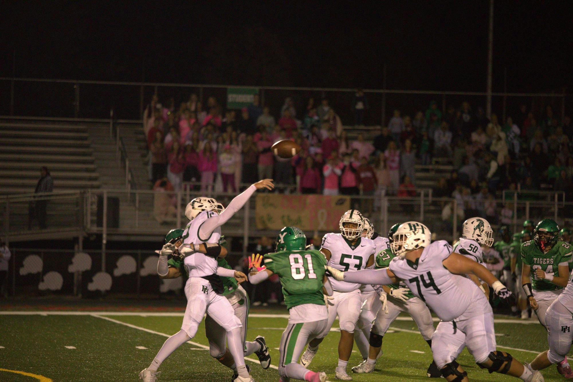 Senior receiver and linebacker Cole Perdue gets around the edge to put pressure on the Arabians quarterback on Oct 10 at Tiger Stadium. Yorktown fell to Pendleton Heights 24-22. Photo by Kyle Stout
