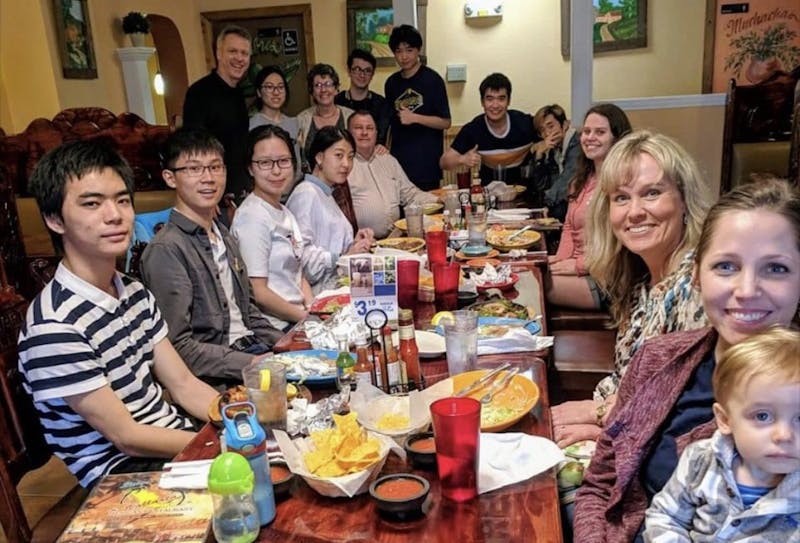 Students pose along with their host families at the student/host family dinner. Students from China and South Korea studying at Indiana Academy this fall will be staying with host families through the Foreign Links Around the Globe (FLAG) program. Robyn Whaley, Photo Provided