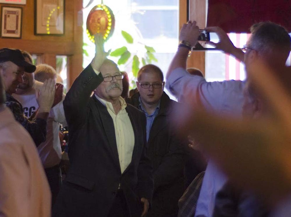 John Gregg enters the Pickled Peach to a crowd of supporters. Gregg announced that he is down three points to Republican Mike Pence. DN PHOTO COREY OHLENKAMP