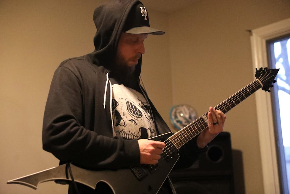 Guitarist Tommy Miller playing his guitar while practicing with his group “Void King” in their home March 21, 2024 in Muncie, Ind. Paola Fernandez Jimenez, Ball Bearings