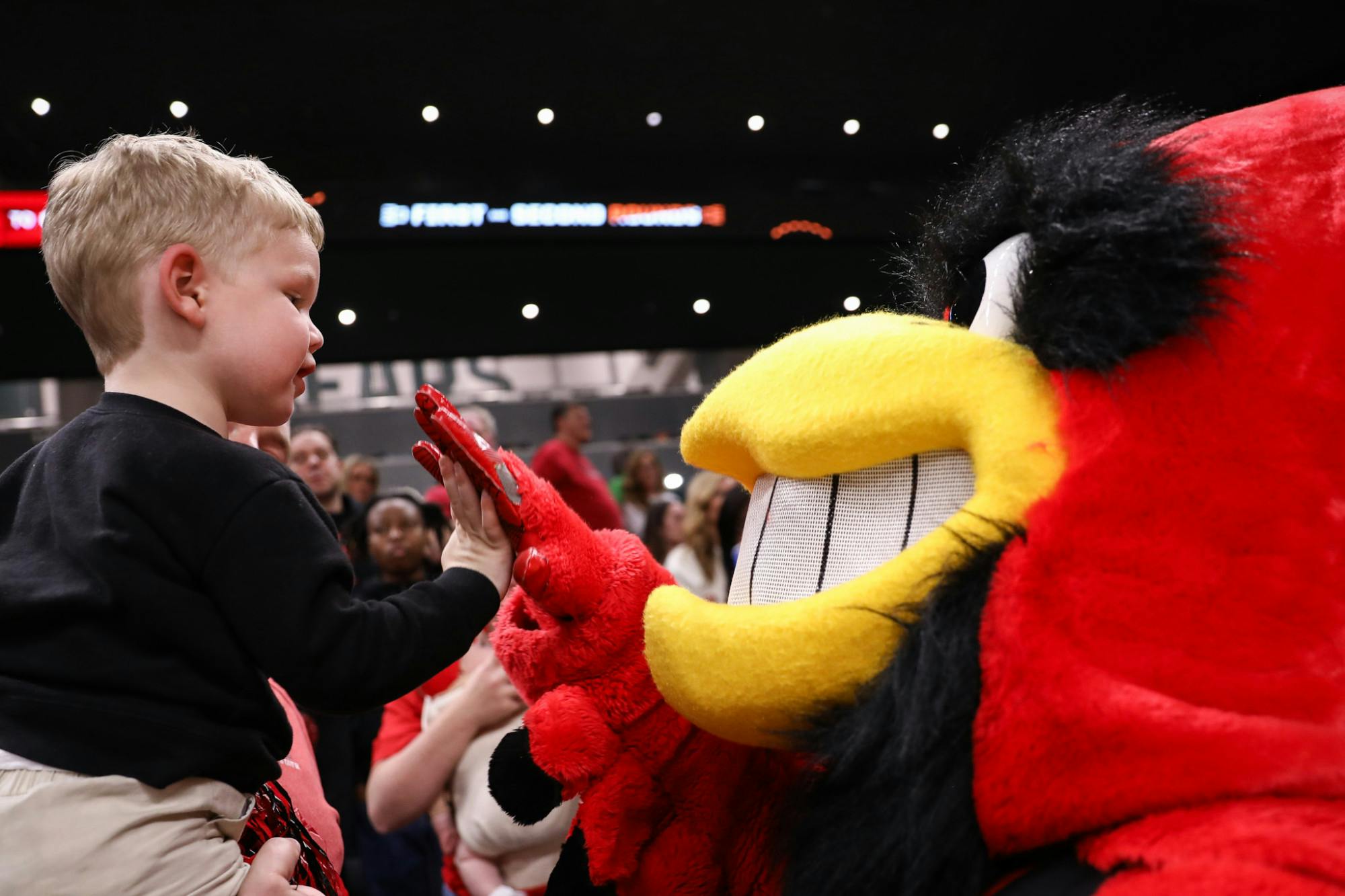 Ball State mascot Charlie Cardinal high-fives a young fan during the NCAA Women's Basketball Tournament on March 21 at Foster Pavilion in Waco, Texas. Andrew Berger, DN 