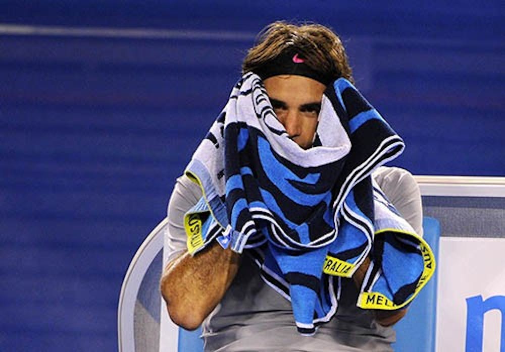 Roger Federer takes a break during the Australian Open in Melbourne, Australia, on Saturday, January 19, 2013. Federer captured his 900th career win at the French Open last week. MCT PHOTO