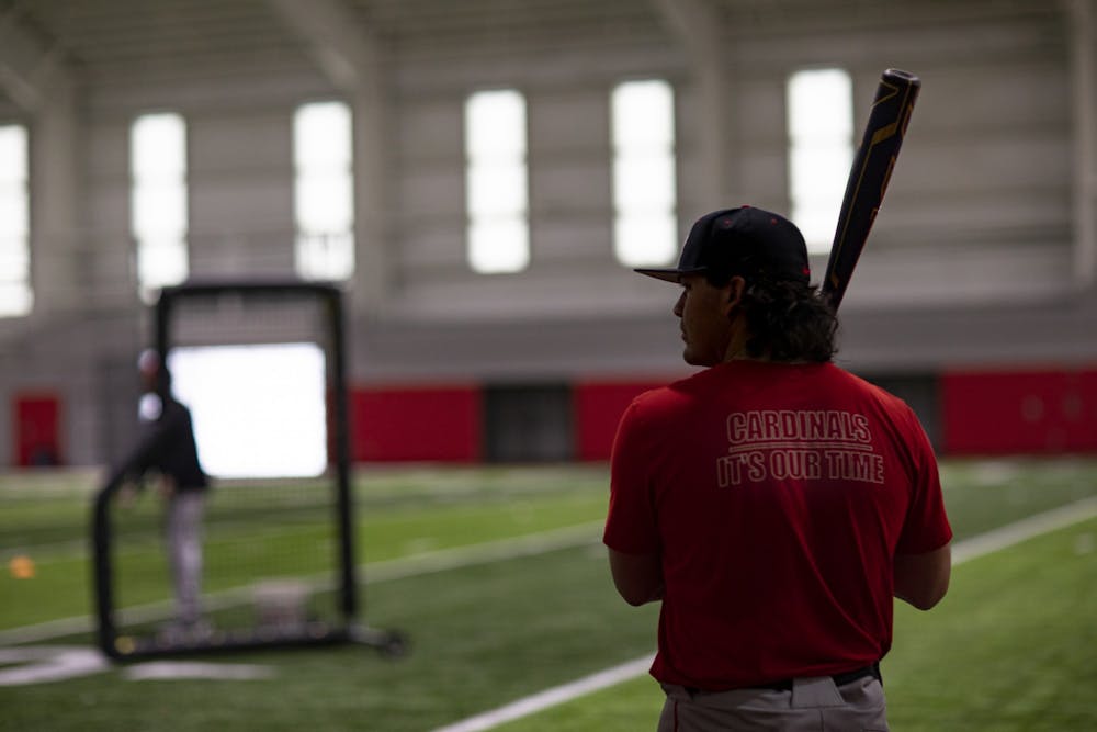 <p>Freshman catcher CJ Horn looks to his third base coach for a sign at Scheumann Family Indoor Practice Facility Feb. 10. Ball State finished the 2021 season with a record of 38-18. Jacy Bradley, DN</p>