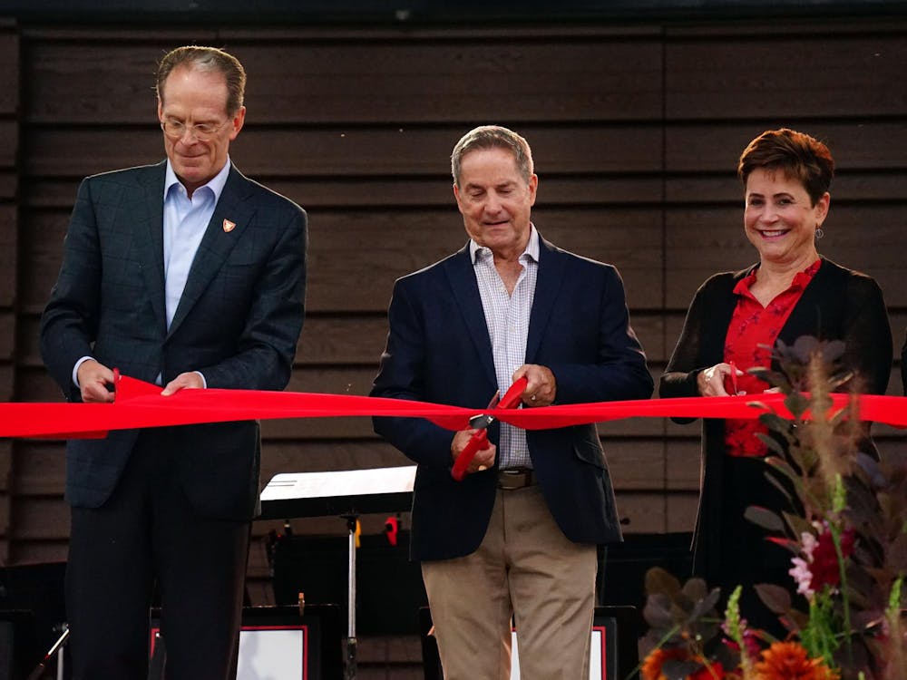 During the ceremony opening of the Brown Family Amphitheater, donor Charles Brown cuts the ribbon with other members from the Board of Trustees and President Geoffrey Mearns. The ceremony was followed by a free jazz concert. Kate Farr, DN