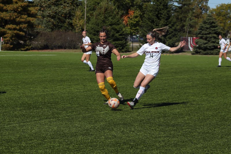 Fifth-year midfielder Sammi Corcoran fights for the ball against number 19 on the opponent team, Eastern Michigan, in the first half of the game on Oct. 9 at Brinner Sports Complex. Eve Green, DN