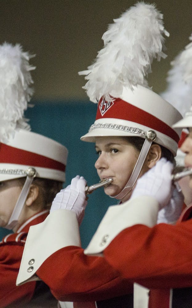 Members of the Pride of Mid-America Marching Band tries to rally the crowd during the mayor's luncheon Jan. 3 at the Mobile Convention Center in Mobile, Ala. DN PHOTO COREY OHLENKAMP