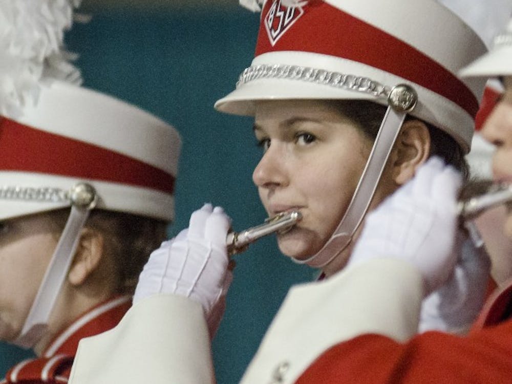 Members of the Pride of Mid-America Marching Band tries to rally the crowd during the mayor's luncheon Jan. 3 at the Mobile Convention Center in Mobile, Ala. DN PHOTO COREY OHLENKAMP
