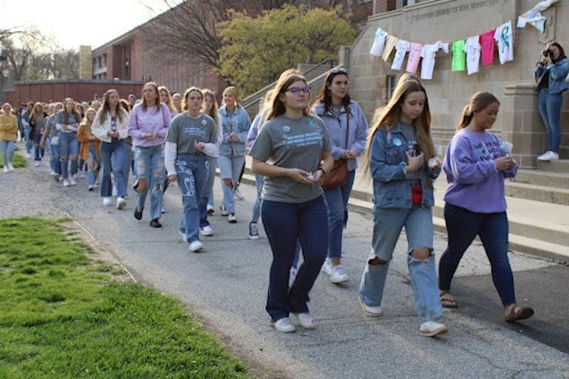 Members of the Ball State Chapter of Alpha Chi Omega participate in the silent march around the quad for Take Back the Night April 27. The event was spearheaded by Alpha Chi Omega’s Vice President of Philanthropy Ayva Wiseman. Sarah Olsen, DN
