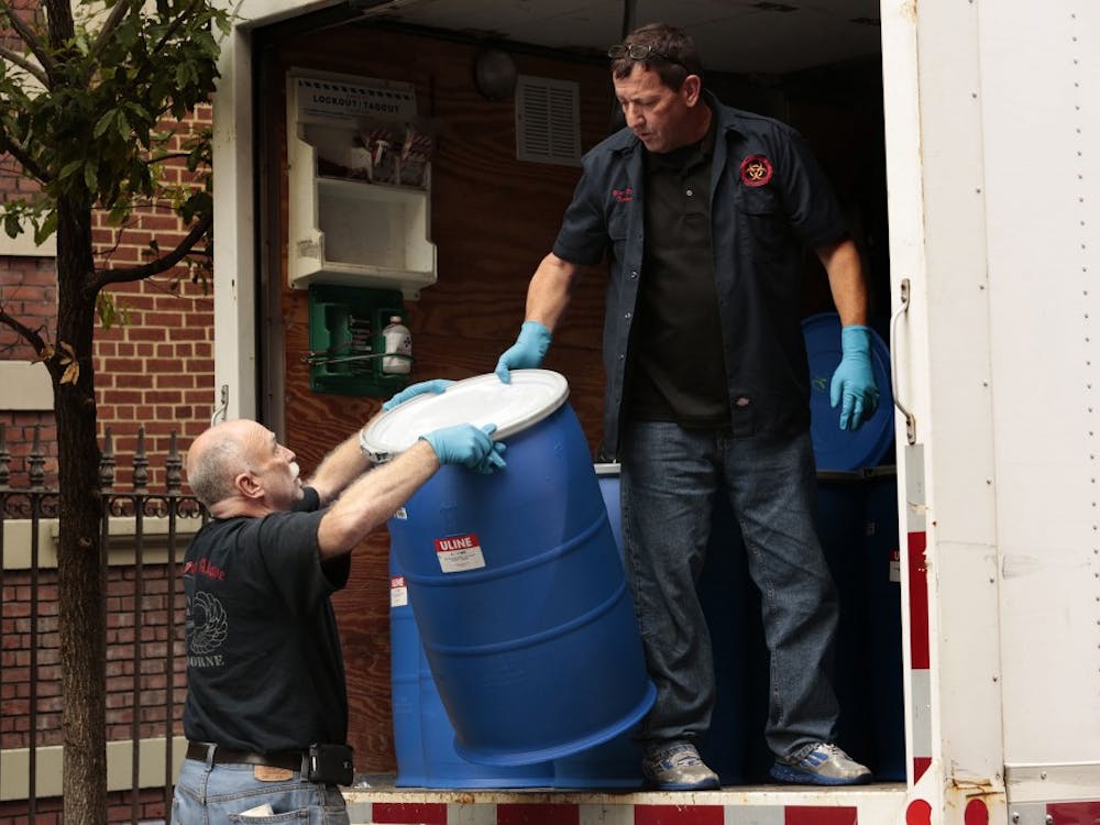 At the apartment of Dr. Craig Spencer, a crew arrives to carry in supplies that will be used to remove belongings from the building in Harlem on Friday, Oct. 24, 2014. Dr. Spencer is the first reported case of Ebola in New York. (Carolyn Cole/Los Angeles Times/MCT)