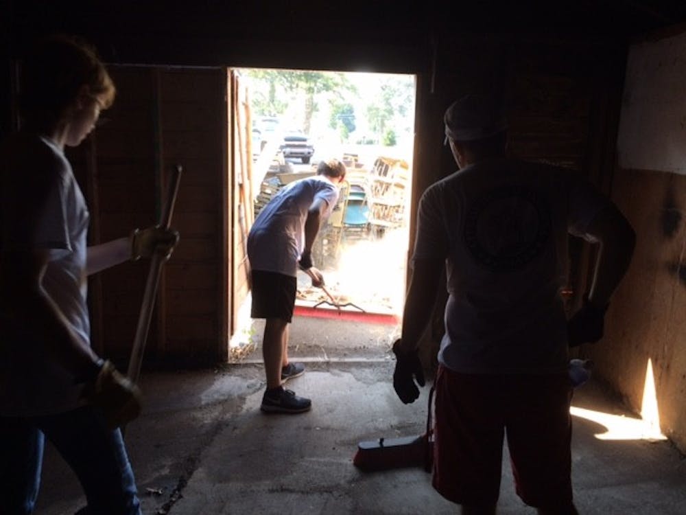 <p>Brady Conner, 17, helps sweep a shed to contribute to the United Way Day of Action. <em>PHOTO BY MICHAEL KUHN</em></p>