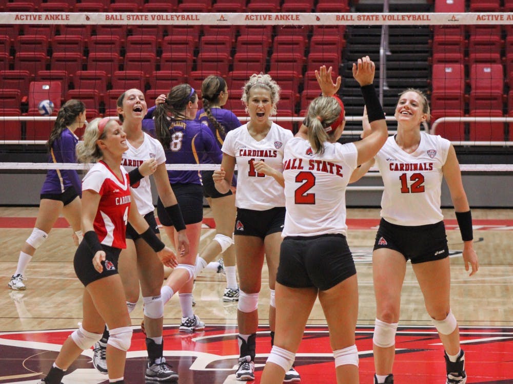 The women's volleyball team celebrates after scoring a point in the first game of the Active Ankle Challenge against Albany on Aug. 28 at Worthen Arena. DN PHOTO MAKAYLA JOHNSON