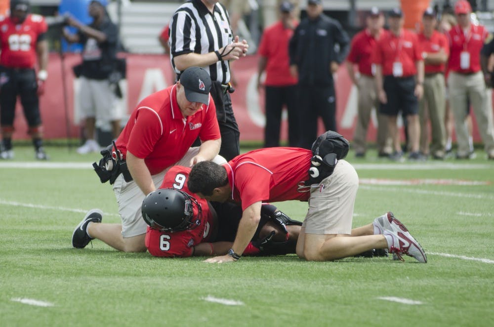 Sophomore safety Dae'Shaun Hurley reacts to injuring his leg during the home opener against Colgate on Aug. 30 at Scheumann Stadium. It is reported that Hurley tore his ACL. DN PHOTO BREANNA DAUGHERTY 