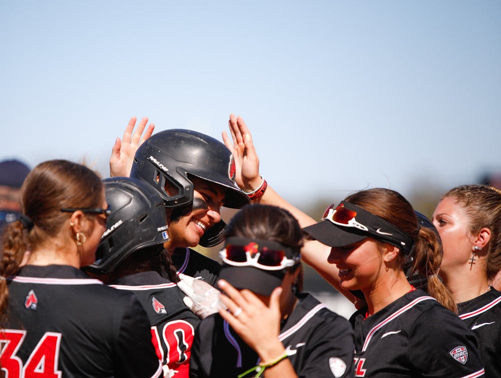 <p>Junior utility McKayla Timmons is surrounded by teamates after hitting a home run against Bowling Green April 13 at First Merchants Ballpark Complex. Timmons had three homes runs over the two game series. Andrew Berger, DN</p>