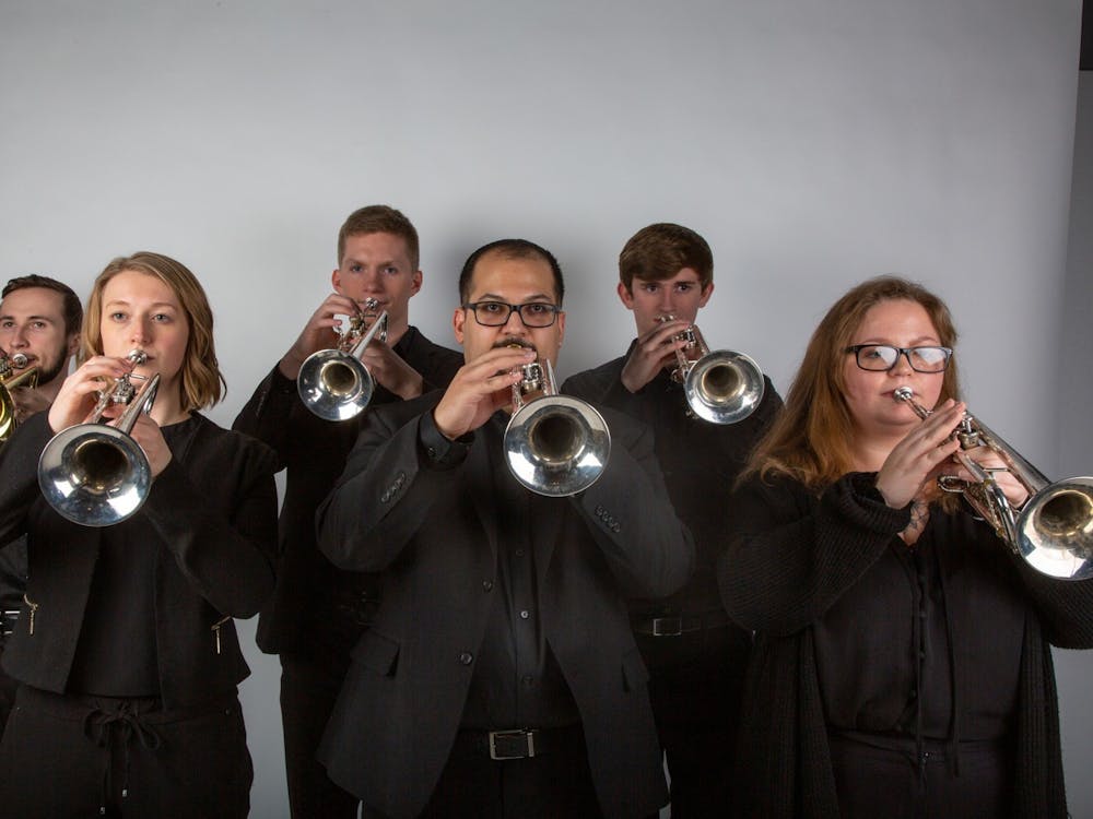 (Left to right) Kieran McNamara, Hannah Weibert, Grant Mason, Eric Rodriguez, Alec Shilling and Jenna Tribbett hold their trumpets in unison Feb. 17, 2020. Jaden Whiteman, DN