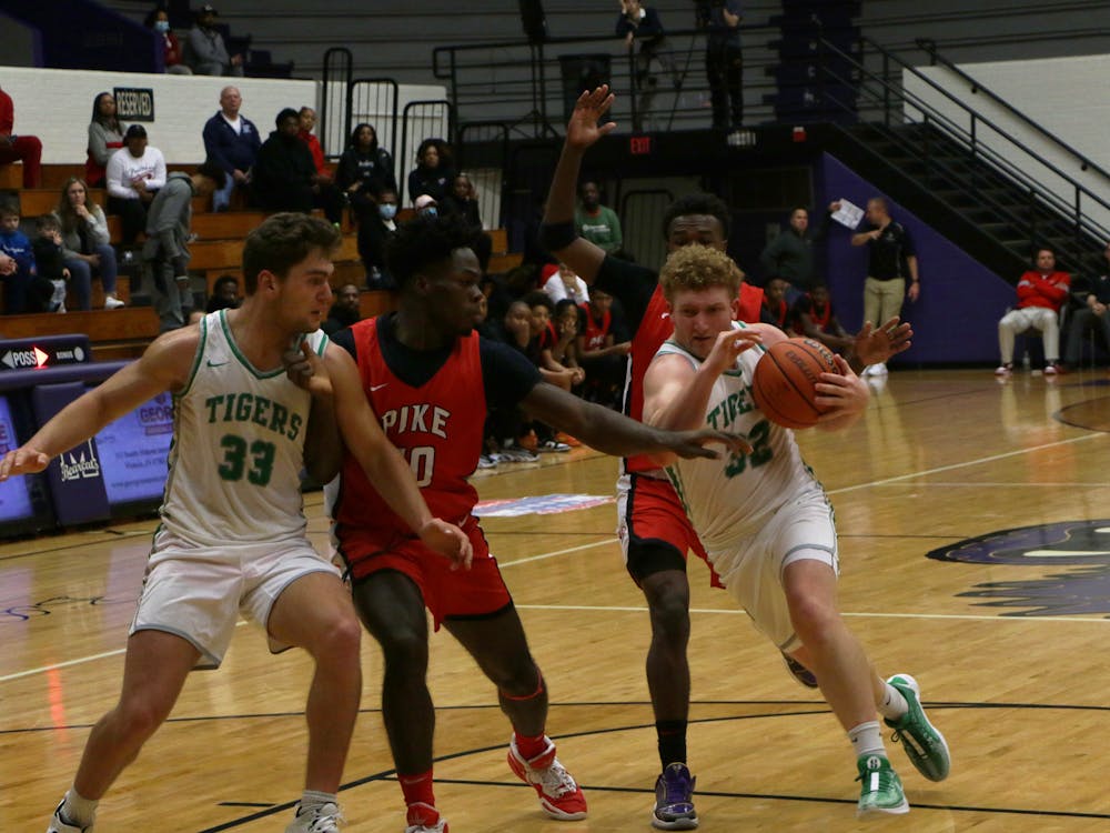 Yorktown senior Jacob Grim drives into the paint against Pike. The game was a part of the first Fieldhouse Classic. David Moore, DN