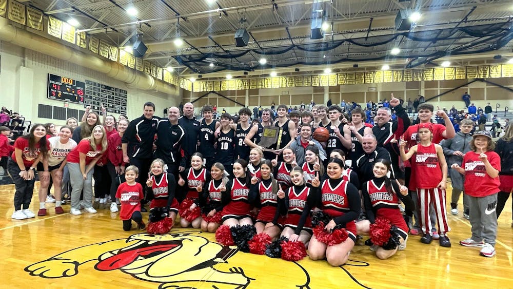 Wapahani boys' basketball, cheerleaders, and fans pose for a picture March 9 after winning the regional championship at Lapel High School. Zach Carter, DN.