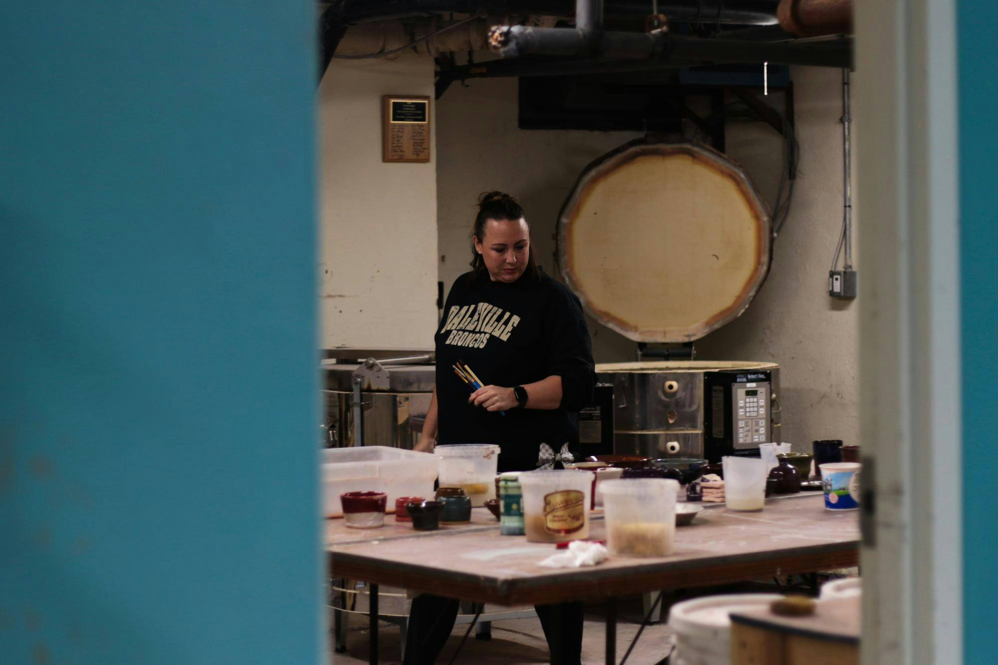 Alissa Davis peruses previous projects in the J. Comb Ceramics Studio Feb. 25 at Cornerstone Center for the Arts. Jasen Combs earned his degree from Ball State University. Jeffrey Dreyer, DN