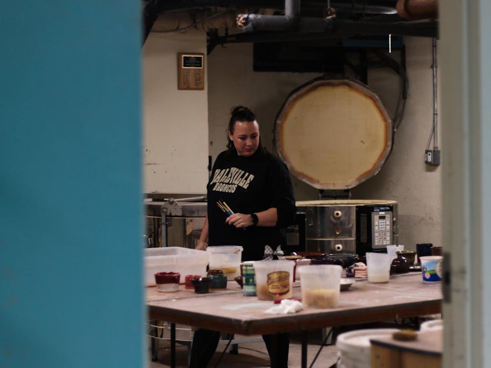 Alissa Davis peruses previous projects in the J. Comb Ceramics Studio Feb. 25 at Cornerstone Center for the Arts. Jasen Combs earned his degree from Ball State University. Jeffrey Dreyer, DN
