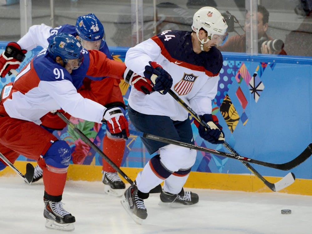 USA defenseman Brooks Orpik, No. 44, works the puck along the boards against Czech Republic forward Patrik Elias, No. 26, and Czech Republic forward Martin Erat, No. 91, during the first period of a Winter Olympics quarterfinal game Wednesday at Shayba Arena in Sochi, Russia. The USA beat the Czech Republic, 5-2. MCT PHOTO 