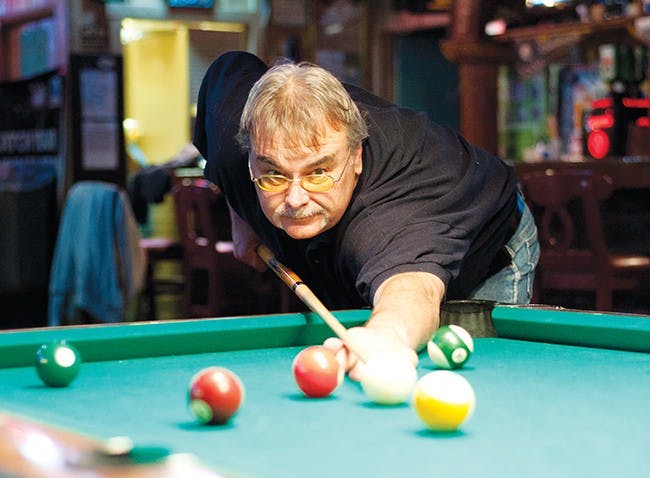 Dan Jones, a Muncie local, cues up before winning his fourth consecutive game against his friend Dave Fields at Big Shots, Wednesday. Dan and Dave play pool at Big Shots monthly while also partaking in a Pool club that meets at Bird's Landing on the weekends. Big Shots has numerous pool tables, bar stools, tables and televisions, catering to a wide range of bar-hoppers within Muncie - those who love pool and those who don't. DN PHOTO RJ RICKER