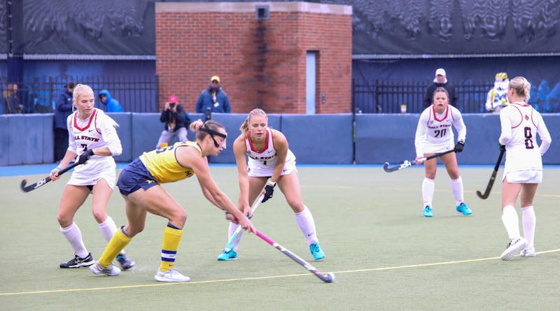 Among others, Ball State field hockey junior midfielder Emma Van Hal defends Lora Clarke in Ann Arbor on Oct. 13. Clarke the only goal of the first half for the Michigan Wolverines. Kyle Smedley, DN