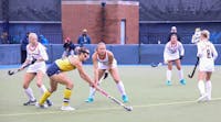 Among others, Ball State field hockey junior midfielder Emma Van Hal defends Lora Clarke in Ann Arbor on Oct. 13. Clarke the only goal of the first half for the Michigan Wolverines. Kyle Smedley, DN