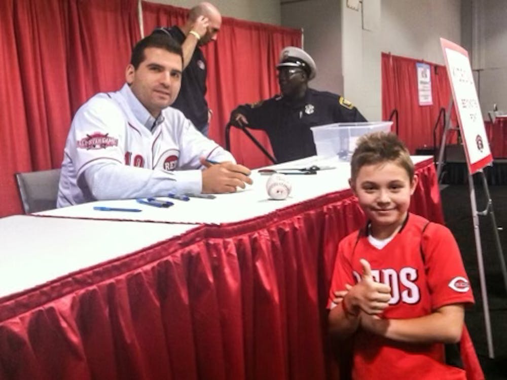 Zach Carter poses for a photo with Cincinnati Reds first baseman Joey Votto at RedsFest in Cincinnati, Ohio, in 2014. Zach Carter, Photo Provided