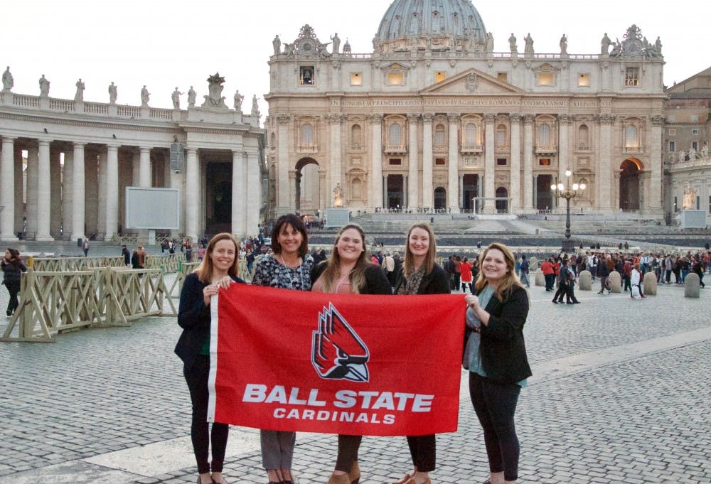 <p>Aiste Manfredini, Dr.&nbsp;Jennifer Palilonis,&nbsp;BriAnna Eikenberry, Sarah Janssen and Jessica Pettengill hold a Ball State flag during their visit to Rome.</p>