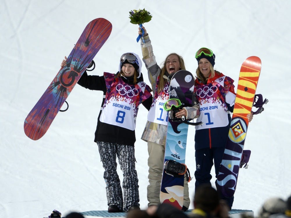 USA's Jamie Anderson, center, of South Lake Tahoe, Calif., celebrates her gold medal win with silver winner Finland's Enni Rukajarvi and bronze winner Great Britain's Jenny Jones in the ladies slopestyle finals during the Winter Olympics at the Rosa Khutor Extreme Park in Sochi, Russia, on Sunday, Feb. 9, 2014. (Nhat V. Meyer/Bay Area News Group/MCT)