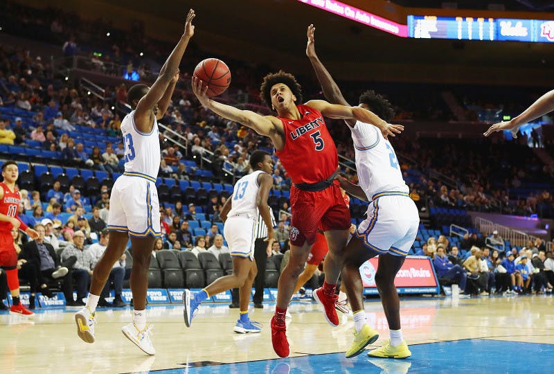 Graduate student forward Keenan Gumbs of the Liberty Flames goes for a layup against UCLA Dec. 29, 2018. Tribune News Service/David Wilson of the Miami Herald photo courtesy 