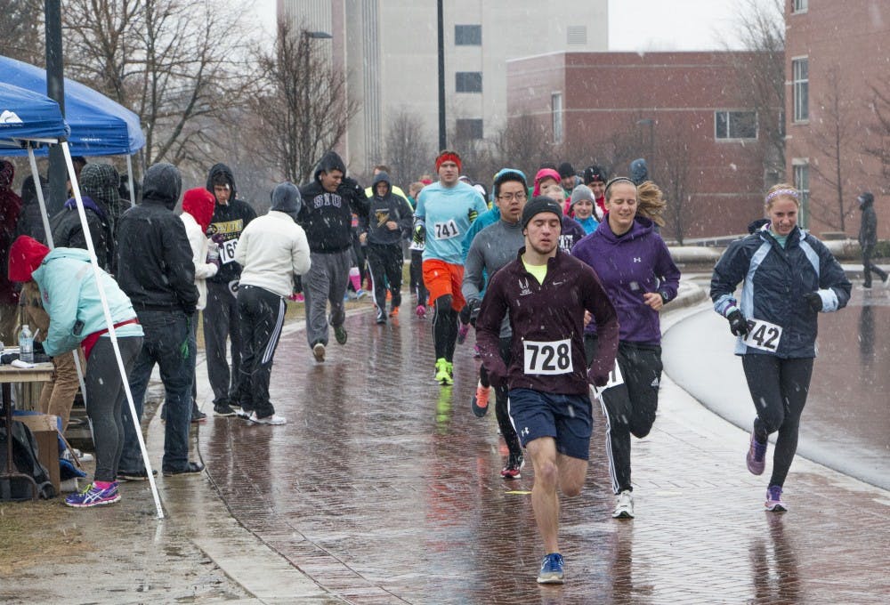 Participants of the 5K race at the McKinley Mile event run despite the weather. Events for the rest of the day were canceled because of weather. DN PHOTO TAYLOR IRBY 
