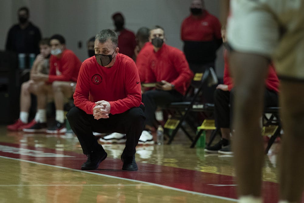 Ball State Cardinals head coach James Whitford squats down and watches the game in the first half agains the Northern Illinois Huskies Jan. 16, 2020, at John E. Worthen Arena. The Cardinals beat the Huskies 78-58. Jacob Musselman, DN