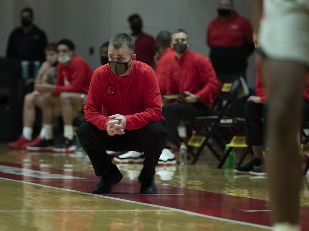 Ball State Cardinals head coach James Whitford squats down and watches the game in the first half agains the Northern Illinois Huskies Jan. 16, 2020, at John E. Worthen Arena. The Cardinals beat the Huskies 78-58. Jacob Musselman, DN