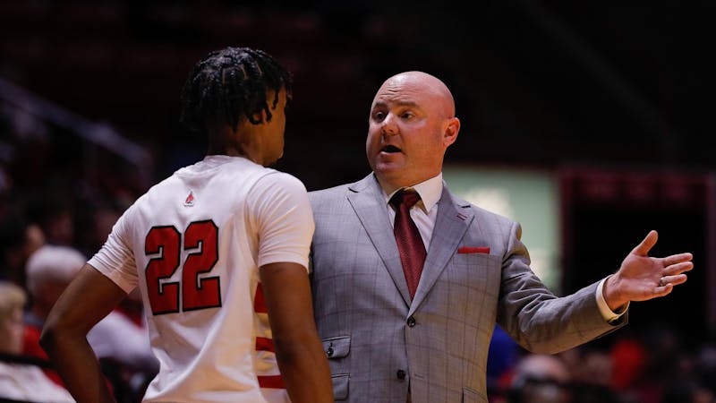 Ball State head coach Micheal Lewis talks to freshman guard TJ Burch during a game against Detroit Mercy Nov. 20 at Worthen Arena. Ball State lost to Detroit Mercy 59-70. Andrew Berger, DN 