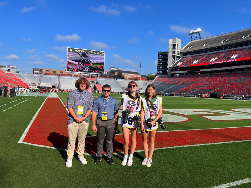 Ball State Daily News associate sports editor Elijah Poe,  reporter Zach Carter, opinion editor Kate Farr, and associate photo editor Mya Cataline pose for photo on the field at Sanford Stadium Sept. 9 in Athens, Ga. Photo provided
